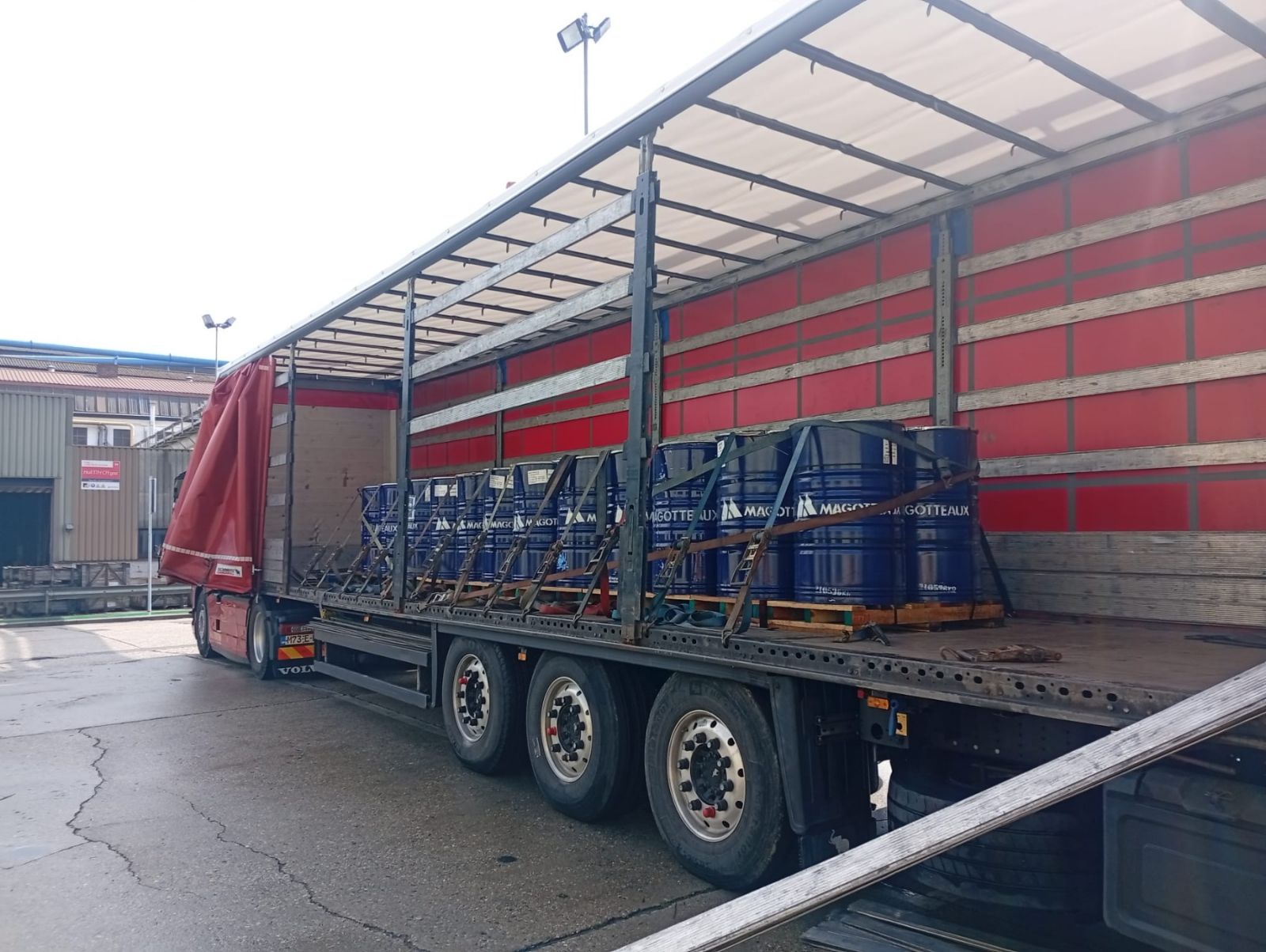 Flatbed trailer loaded with steel drums