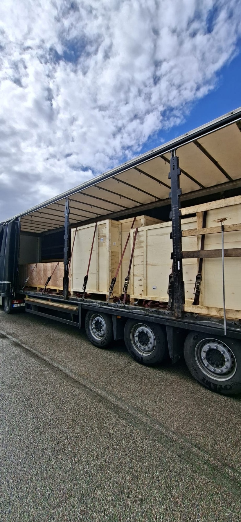 Large wooden crates loaded on curtainsider trailer